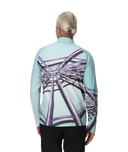 Person wearing a light blue long-sleeve shirt with a geometric pattern on the back, standing against a white background.