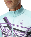Light blue cycling jersey with purple and black design on a person wearing it.