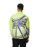 Person wearing a bright green long-sleeve shirt with a unique design on the back, standing against a white background.