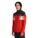 A man wearing a Spyder red and black half zip performance top with a mock neck.