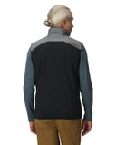 Person wearing a black and gray jacket with a visible brand logo on a white background