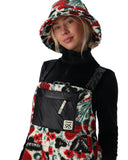 Person wearing a colorful floral-patterned outfit with a black backpack on a white background