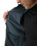 Person wearing a dark jacket with a textured pattern on a white background