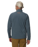 Person wearing a gray pullover with a brand logo on the back, standing against a white background