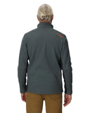 Person wearing a gray jacket with a logo on the back, standing against a white background