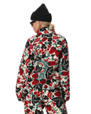 Person wearing a colorful floral patterned outfit on a white background