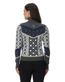 Woman wearing a patterned sweater with a visible brand logo on a white background