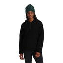 Person wearing a black hoodie and green beanie on a white background