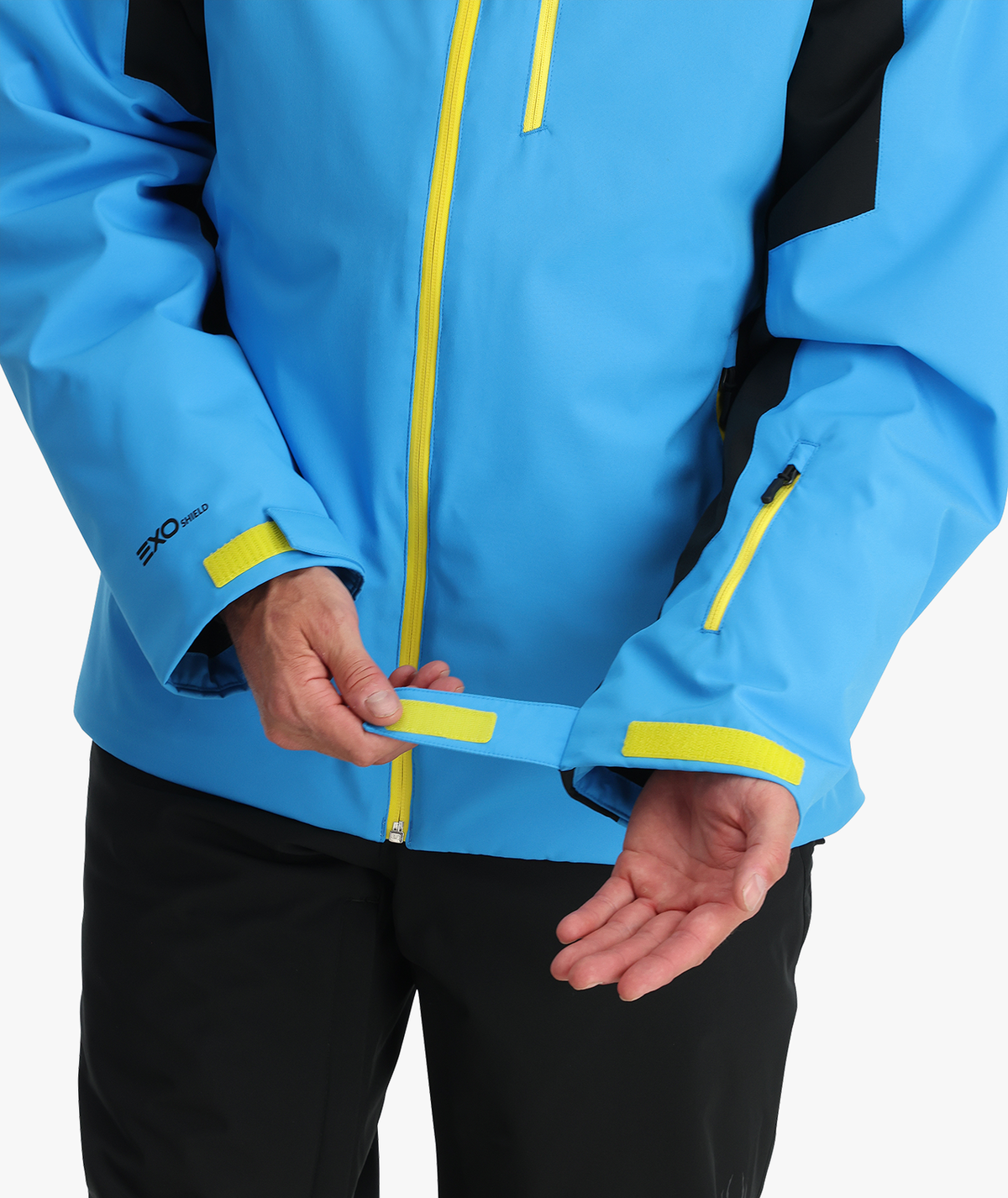 Blue jacket with yellow accents worn by a person on a white background