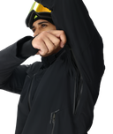 Person wearing a black jacket with a hood, peeking out from under it.