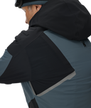 Person wearing a black and gray jacket with a hood on a white background