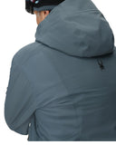 Person wearing a gray jacket with a brand logo on the back against a white background