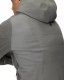 Person wearing a gray jacket with a hood on a white background