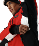 Person wearing a red, black, and white jacket with a brand logo on a white background