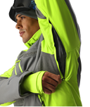 Person wearing a high-visibility jacket with a brand logo on a white background