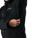 Close-up of a person wearing a black jacket with a brand logo on a white background