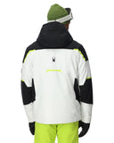 Person wearing a black, white, and green jacket with a visible brand logo on a white background