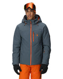 Person wearing a gray jacket with orange accents and orange ski pants on a white background