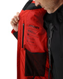 Red jacket with Spyder branding held by a person against a white background