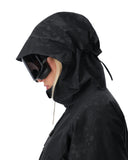 Person wearing a black hooded jacket with a white background