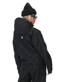 Person wearing a black hooded jacket and pants on a white background