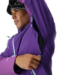 Person wearing a purple jacket with a white background
