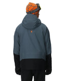 Person wearing a gray and black jacket with a brand logo on a white background