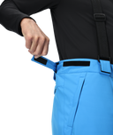 Person wearing black jacket and blue pants with a white background