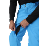 Person wearing bright blue snow pants with a black sleeve on a white background