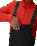 Person wearing a red jacket with a black backpack featuring a logo on a white background