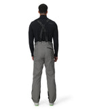 Person wearing a black jacket and gray pants on a white background