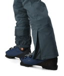 Dark gray pants with blue ankle boots on a white background