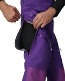 Close-up of a person wearing a purple jacket with a black interior lining.