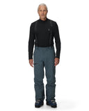 Man wearing a black long-sleeve shirt and dark pants on a white background