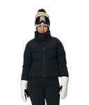 Person wearing a black puffer jacket, white gloves, and a beanie with goggles on a white background