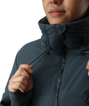 Person wearing a dark blue jacket with a high collar on a white background