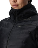 Close-up of a person wearing a black jacket with brand logos on a white background