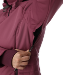 Close-up of a person wearing a maroon jacket with a white background
