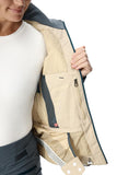 Close-up of a person wearing a beige and gray jacket with a white background