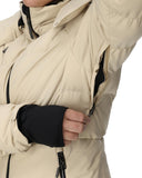 Close-up of a person wearing a beige winter jacket with black gloves on a white background