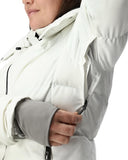 Close-up of a person wearing a white jacket with gray arm cuffs.