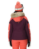 Person wearing a two-tone jacket with fur-lined hood, red beanie, and orange pants on a white background