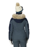 Person wearing a blue winter jacket with fur-lined hood and matching pants on a white background