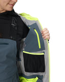 Person wearing a gray and black jacket with a yellow interior, holding a gray and black bag with yellow accents.