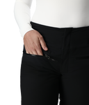 Person wearing black pants with a white shirt, focusing on the pants.