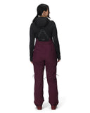 Person wearing a black jacket and maroon pants on a white background