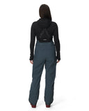 Person wearing a black hoodie and teal pants on a white background