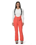 Woman wearing red ski pants with suspenders on a white background