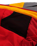 Close-up of a red jacket with a black interior lining and yellow zipper.