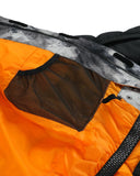 Close-up of a jacket with orange front and gray back, featuring a mesh pocket.